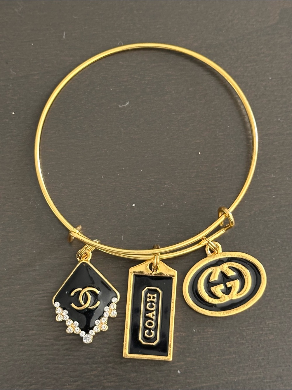 Coach Gold Tone Bangle with Black Enamel Charms